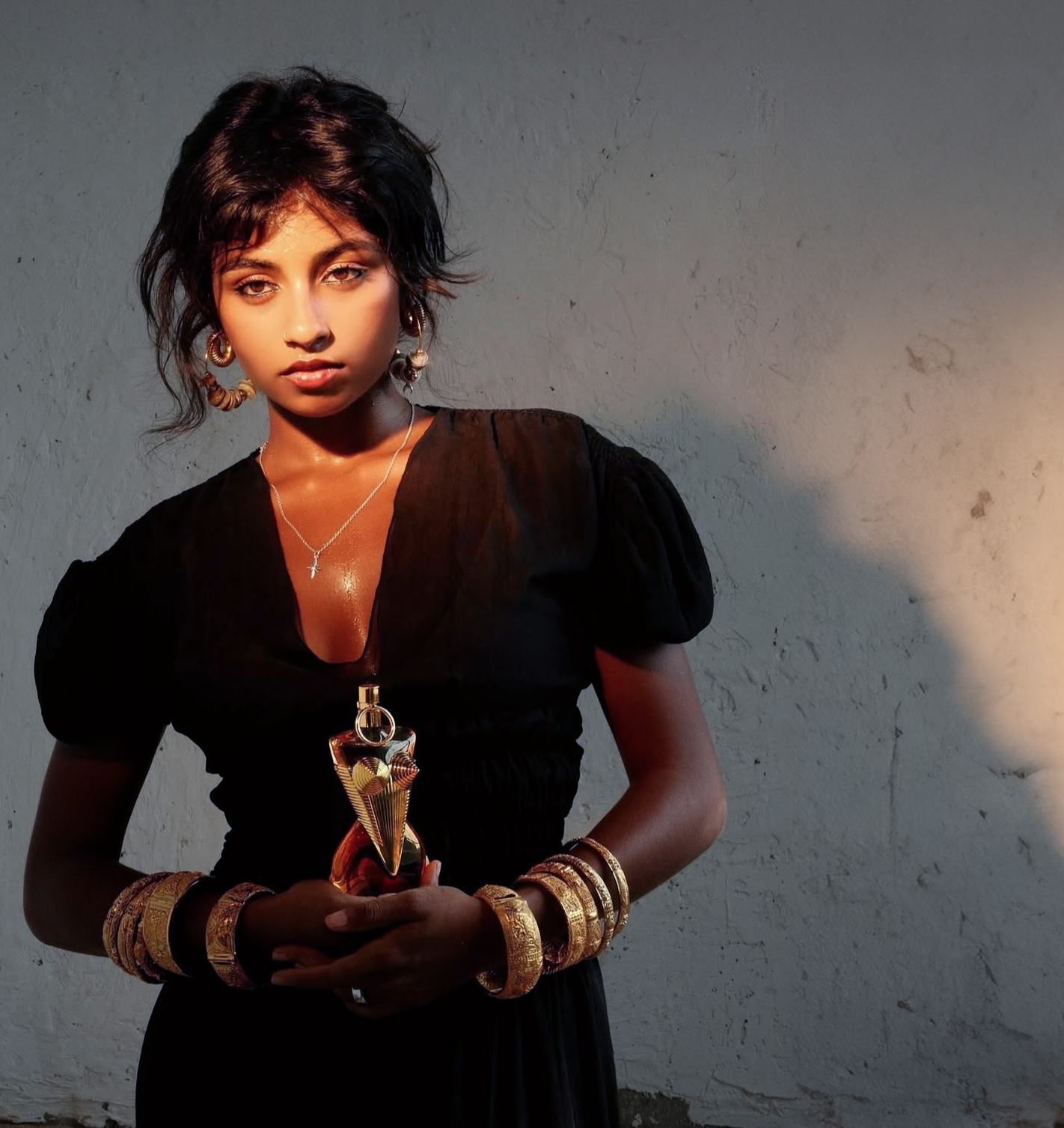 A Picture of Tanya Ravichandran holding a bottle of Jean Paul Gaultier.